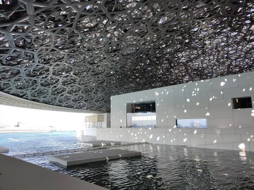 La luce filtra dalle maglie del soffitto creando un'atmosfera onirica che cambia di continuo. Il museo è costruito sull'isola artificiale di Saadiyat, diventata il distretto culturale di Abu Dabhi